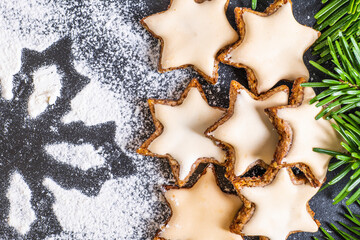 Christmas decorated cinnamon stars with a star made of sieved flour