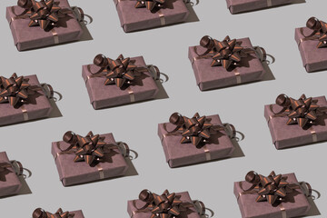 Brown gift box pattern with bow on gray background. Christmas minimalist concept photo