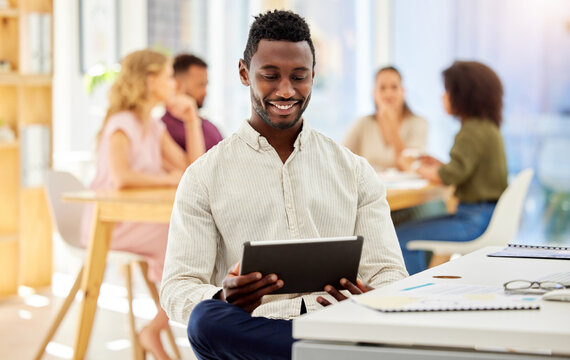 African Businessman Working On A Digital Tablet While Sitting By His Desk In A Corporate Office. Happy, Professional And Black Man Doing Research On The Internet Or A Website With A Mobile Device.