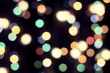 Fototapeta premium multicolored festive lights on a black background screensaver backdrop