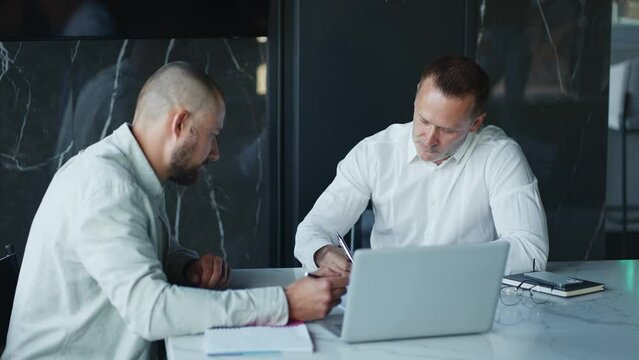 Happy company manager handshake promote praise male intern worker in office, motivated young employee rewarded appreciated for good work results get positive feedback concept team applause at meeting