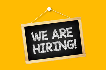 We are hiring written chalkboard with wooden frame and rope for hanging. Recruitment concept. 