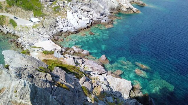Panning Downwards Shot Of Tourists Walking Away From TheStunning Agios Ioannis Kastri That Appeared In Mamma Mia