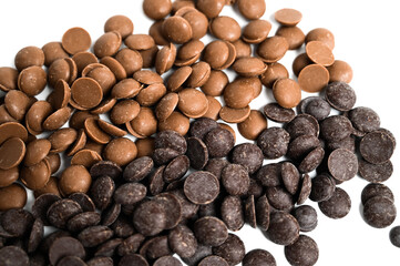 Close up of dark and milk couverture chocolate isolated on white. Chocolate callets isolated on white.