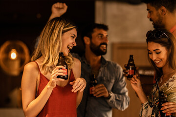 Happy young people drinking bear at pub
Party in the pub