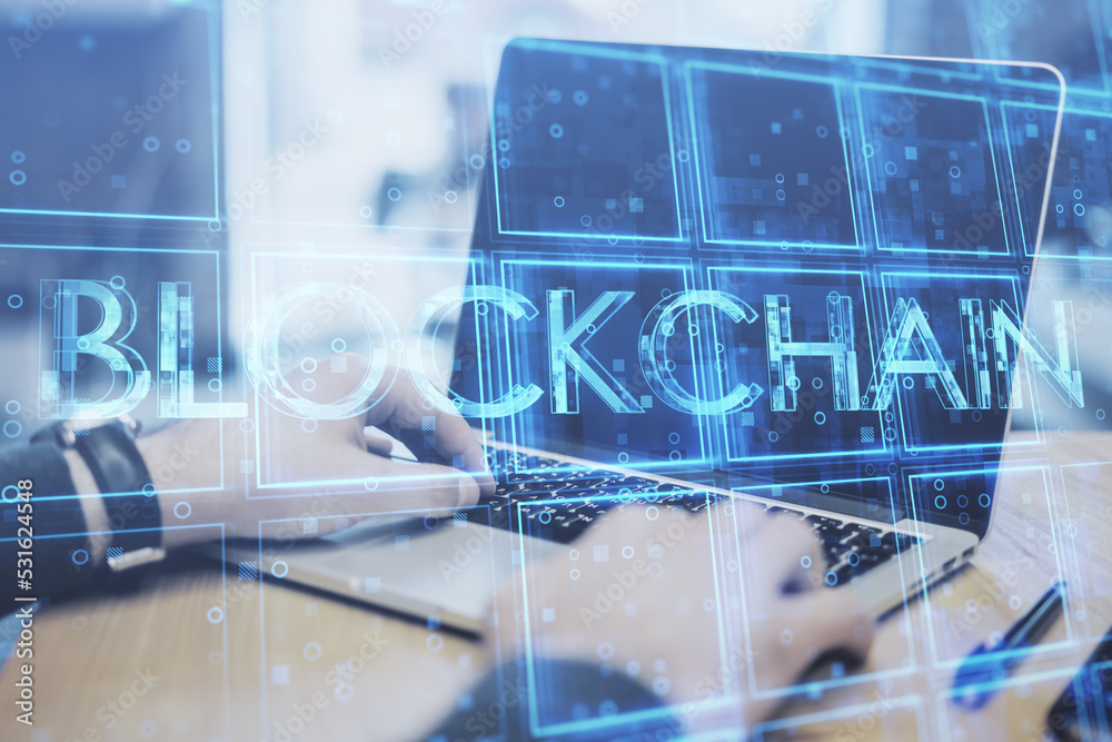 Poster close up of businessman hands using laptop keyboard with creative blue cubes blockchain text hologra