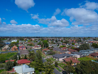 Fototapeta premium Panoramic aerial Drone view of Melbournes suburbs and CBD looking down at Houses roads and Parks Victoria Australia. Beautiful colours at Sunset