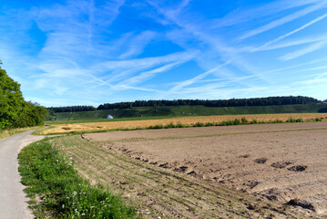 Freshly planted field with geometric furrows and hills on a sunny summer day at rural village Kleinandelfingen on a sunny summer day. Photo taken July 12th, 2022, Andelfingen, Switzerland.