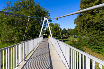 Pedestrian rope bridge over Thur River at village Kleinandelfingen, Canton Zürich, on a sunny summer morning. Photo taken July 12th, 2022, Kleinandelfingen, Switzerland.