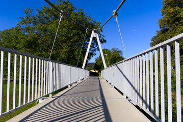 Pedestrian rope bridge over Thur River at village Kleinandelfingen, Canton Zürich, on a sunny summer morning. Photo taken July 12th, 2022, Kleinandelfingen, Switzerland.