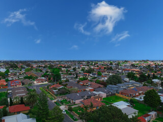 Obraz premium Panoramic aerial Drone view of Melbournes suburbs and CBD looking down at Houses roads and Parks Victoria Australia. Beautiful colours at Sunset