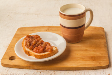 Milk drink and apple savory snack on a piece of bread.