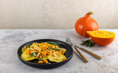 Seasonal autumn recipe. Pumpkin ravioli with sage, parmesan, and olive oil. Great meal for lunch or dinner, vegetarian food. 