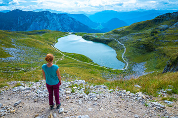Female hiker enjoying view of the Augstsee on top of the Loser and the surrounding mountain range, Ausseer Land, Salzkammergut, Styria, Austria