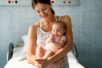Portrait of beautiful mother with her baby in the hospital background