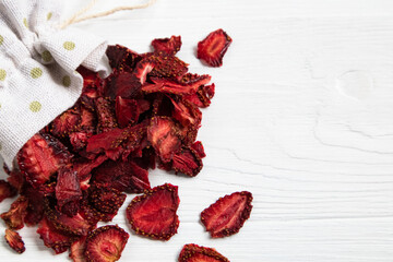 Dried strawberries on a white background with a place for text. Preparations for a pleasant and healthy tea party.