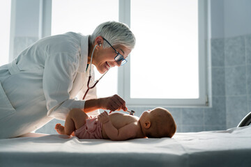 Pediatrician examining little baby to prevent diseases - obrazy, fototapety, plakaty