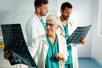 Doctors discussing patient's diagnosis looking at x-rays in a hospital