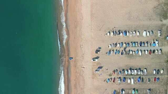 Aerial view over some fishermen's boats parked on the beach with views of the Mediterranean on the Costa del Maresme province of Barcelona