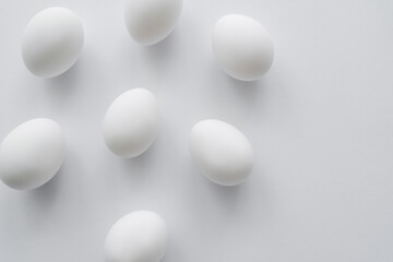 Top view of natural chicken eggs on white background.