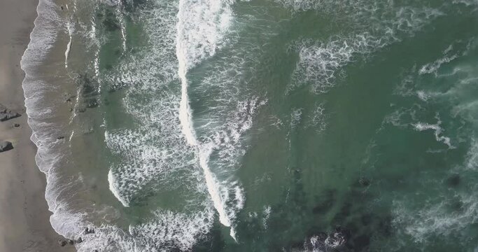 aerial view of afife in Viana do Castelo, Portugal. Amazing view of some and perfect waves crashing on the ocean. some rocks in middle of sea.