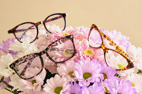 several trendy modern eye glasses on flowers. trendy eyeglasses