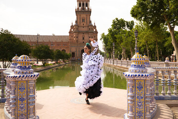 Flamenco dancer woman, beautiful brunette teenager dressed in typical costume with ruffles and...