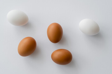 Top view of chicken eggs on white background.