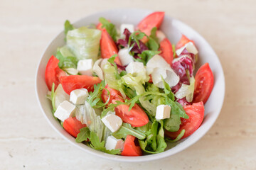 Delicious fresh Greek salad with tomato, cucumber, sweet pepper and feta cheese