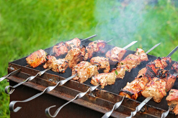 Cooking shish kebab on the grill. Cooking marinated meat on coals. Cooking meat on coals.