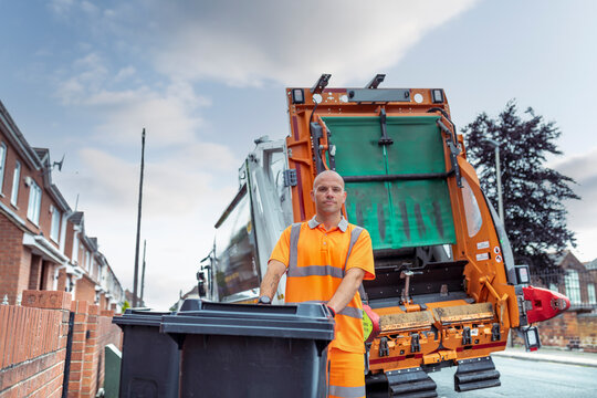 Portrait Of Refuse Collector With Bin And Refuse Truck