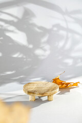 Natural wooden desk and podium on gray background with shadows. Empty showcase for packafing product presentation. Background for cosmetic products, Scene with dark shadows. Mock up pedestal. 