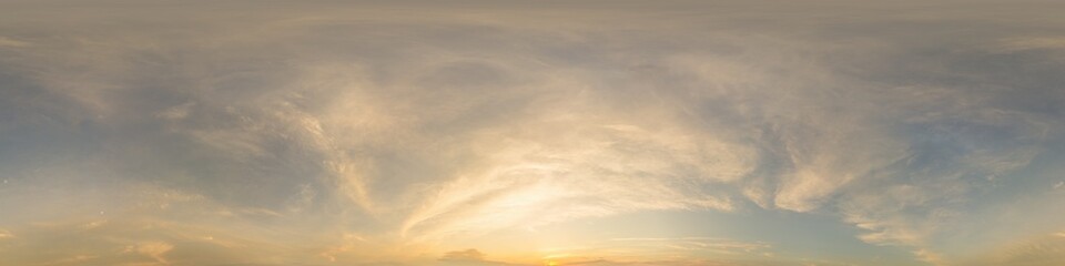 Fototapeta premium Golden glowing sunset sky panorama with Cirrus clouds. Hdr seamless spherical equirectangular 360 panorama. Sky dome or zenith for 3D visualization and sky replacement for aerial drone 360 panoramas.