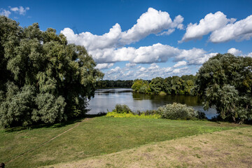 landscape with a river against a blue sky and a sunny day