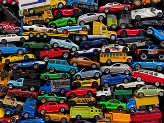 Traffic jam scene made with little toy cars. Side view of colorful car toys. Group of car toys on...