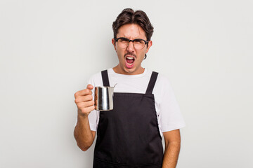 Young hispanic barista man isolated on white background screaming very angry and aggressive.
