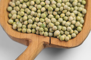 Full carved cracked rustic bowl with dried green peas closeup
