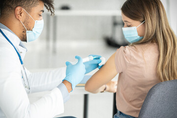 Close up of a doctors hands giving vaccine