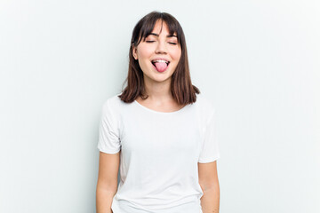 Young caucasian woman isolated on white background funny and friendly sticking out tongue.