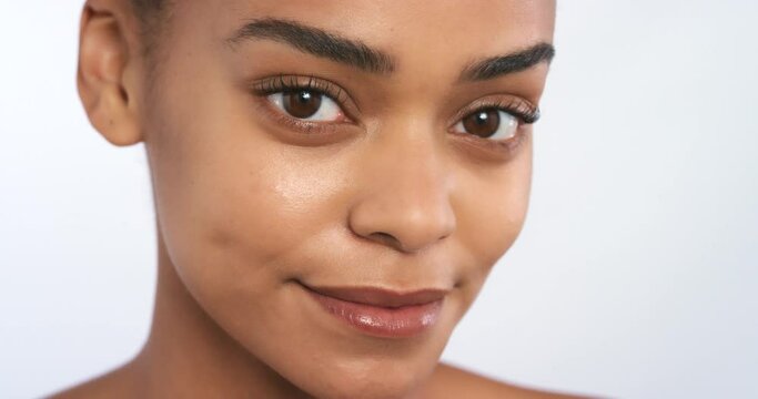 Beauty, skincare and wellness woman face against a white studio mockup background. Portrait of black female model with glowing, healthy or beautiful clean skin looking satisfied with healthy results