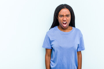 Young African American woman with braids hair isolated on blue background shouting very angry, rage concept, frustrated.