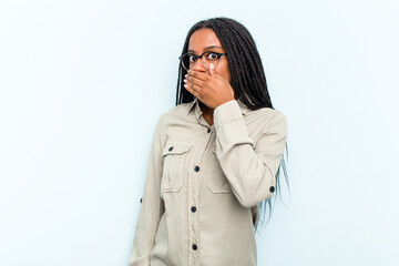 Young African American woman with braids hair isolated on blue background covering mouth with hands looking worried.