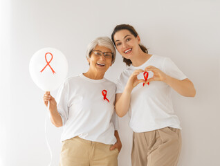 Smiling women with red satin ribbon