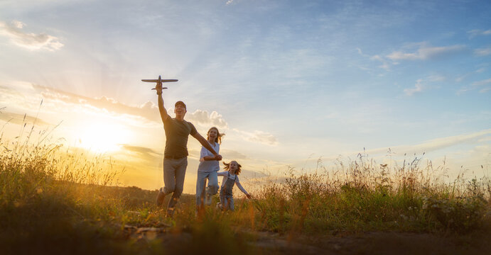 Happy family at sunset