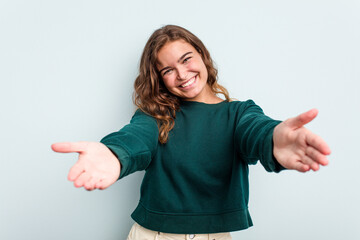 Young caucasian woman isolated on blue background showing a welcome expression.