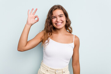 Fototapeta na wymiar Young caucasian woman isolated on blue background cheerful and confident showing ok gesture.