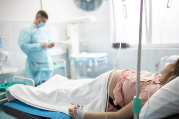 In the Hospital Woman Giving Birth Support by her Husband. Modern Delivery Ward. Painless...