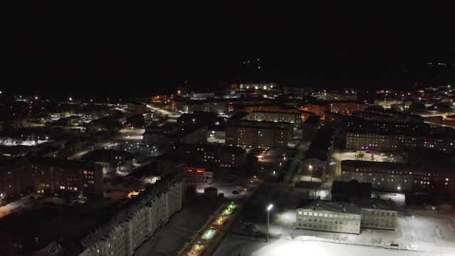 Aerial view of the night landscape of the city in the Arctic in the Arctic circle in winter. Establishing shot of the night Arctic city of Salekhard in winter