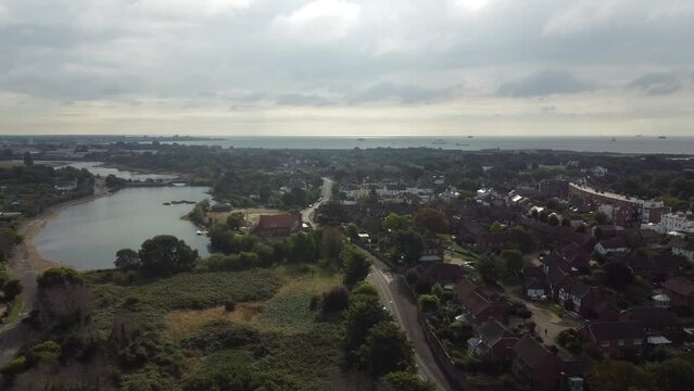 Aerial footage of Stokes Bay in Gosport, England, in cloudy sky background
