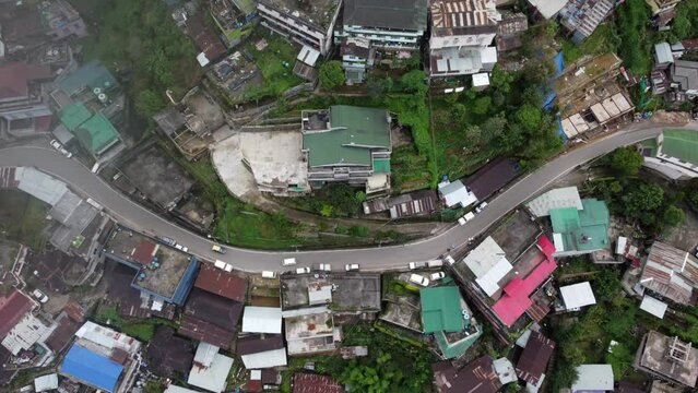 A straight down view aerial flight over the houses and roads in the hill city of Kohima in Nagaland northeast India timelapse.